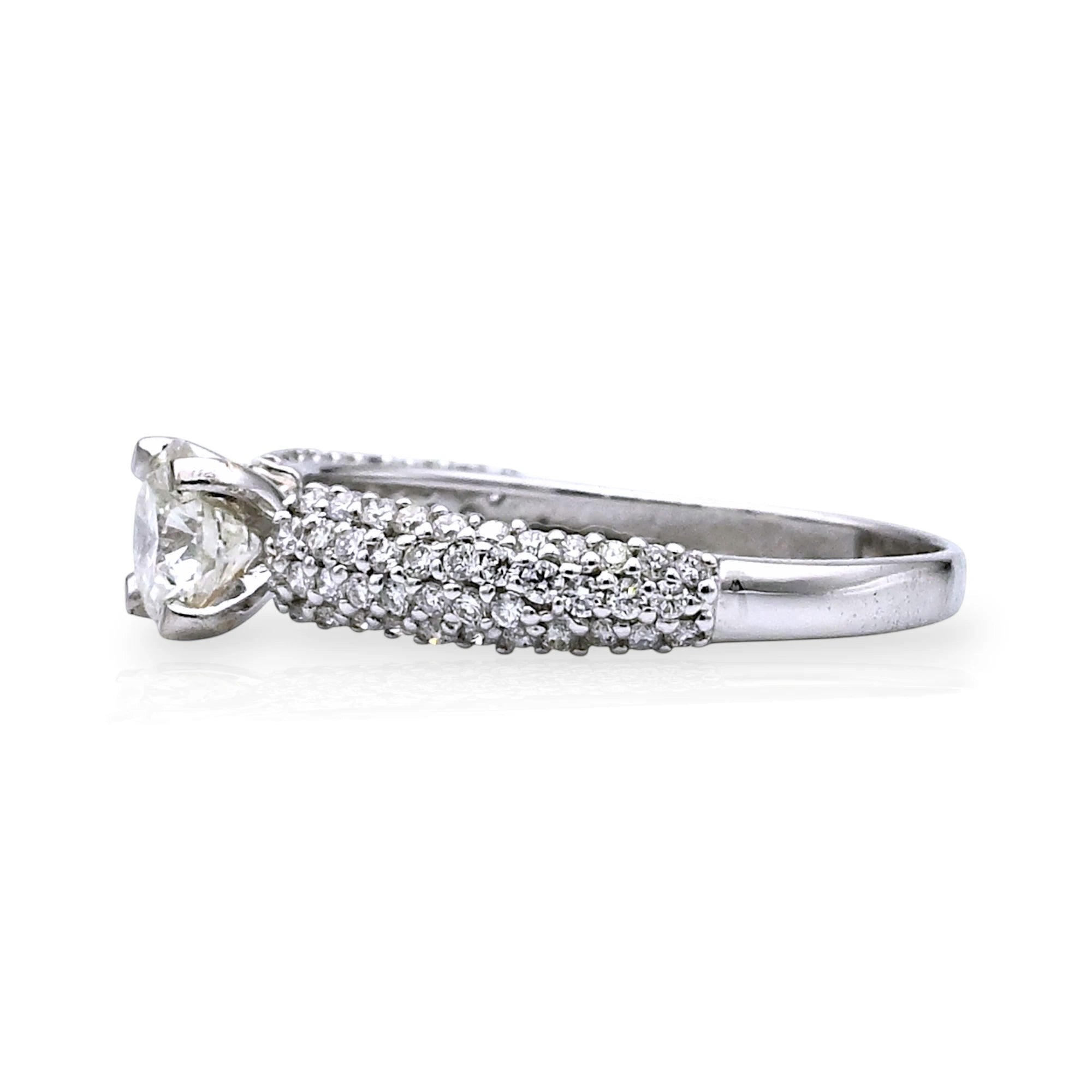 Kef Diamonds 18k white gold engagement ring with a round solitaire diamond and pavé-set diamond band side view