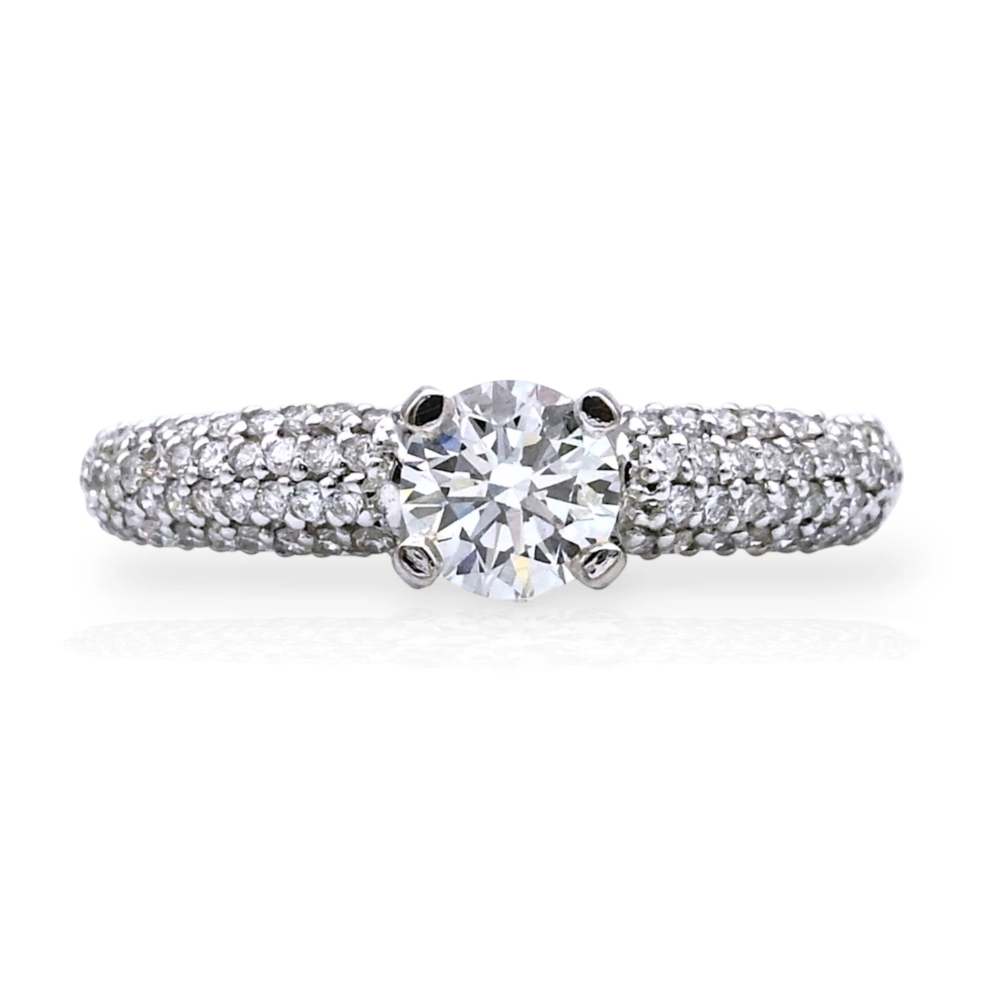 Kef Diamonds 18k white gold engagement ring featuring a 0.54 ct round solitaire diamond with pavé-set diamond band.